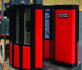 A Cray-2 supercomputer rests on a pallet held by a forklift. The red and black device is nearly as tall as the forklift and slightly wider.