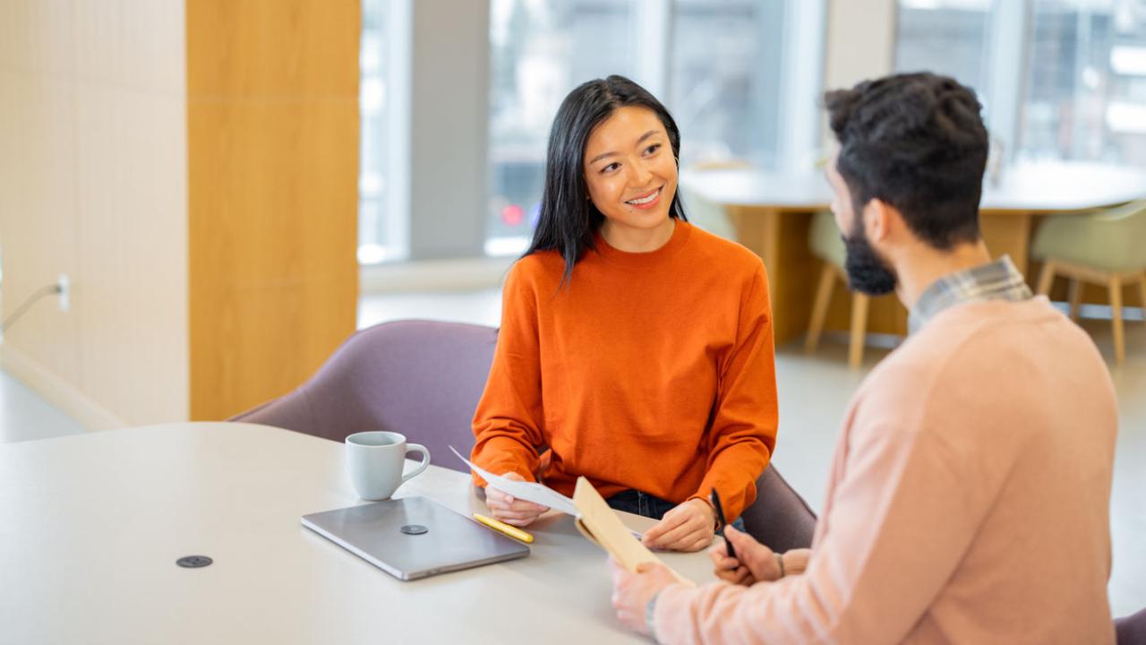 Image of a human resources manager meeting with an employee.