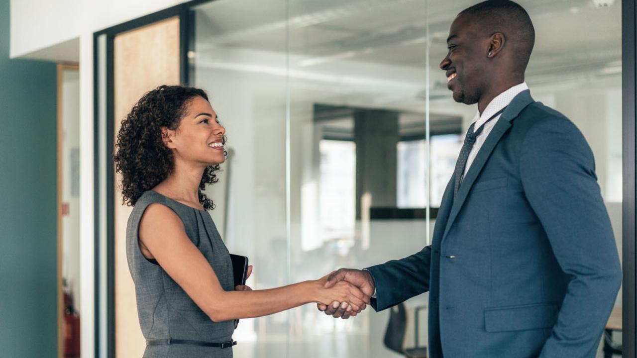 Image of a recruiter shaking a candidate&#039;s hand. 