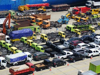 An assortment of surplus government vehicles sit idle in a storage lot.