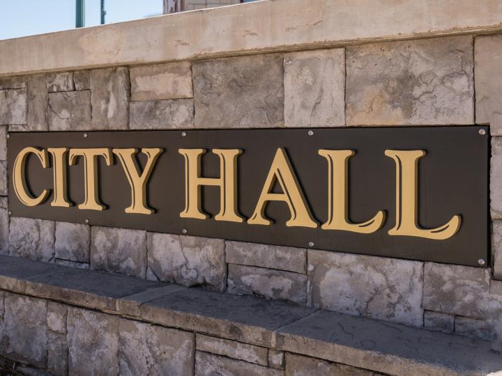 Image of a sign that says, &quot;CITY HALL.&quot;