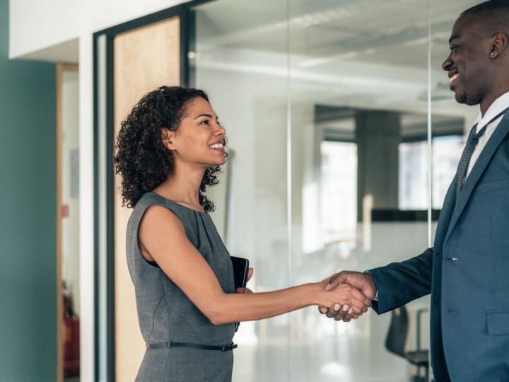 Image of a recruiter shaking a candidate&#039;s hand. 