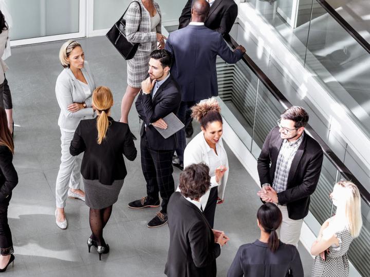 Image of members of the public mingling with human resources professionals.